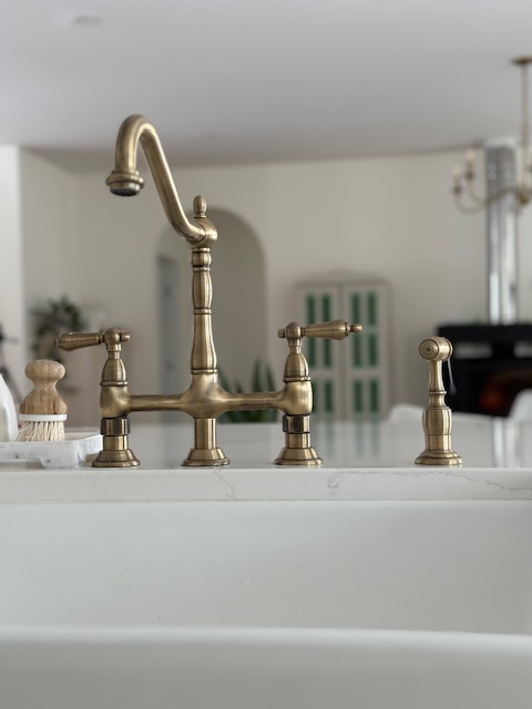 Kitchen sink with brass faucet