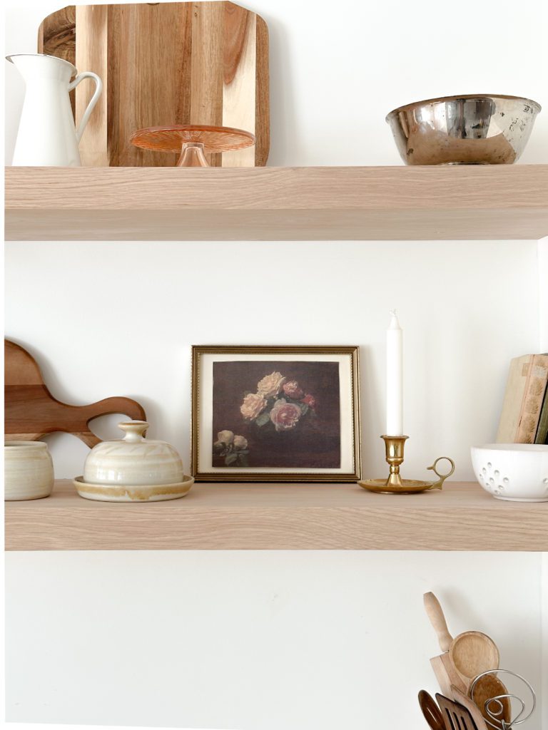 open shelving with printed art