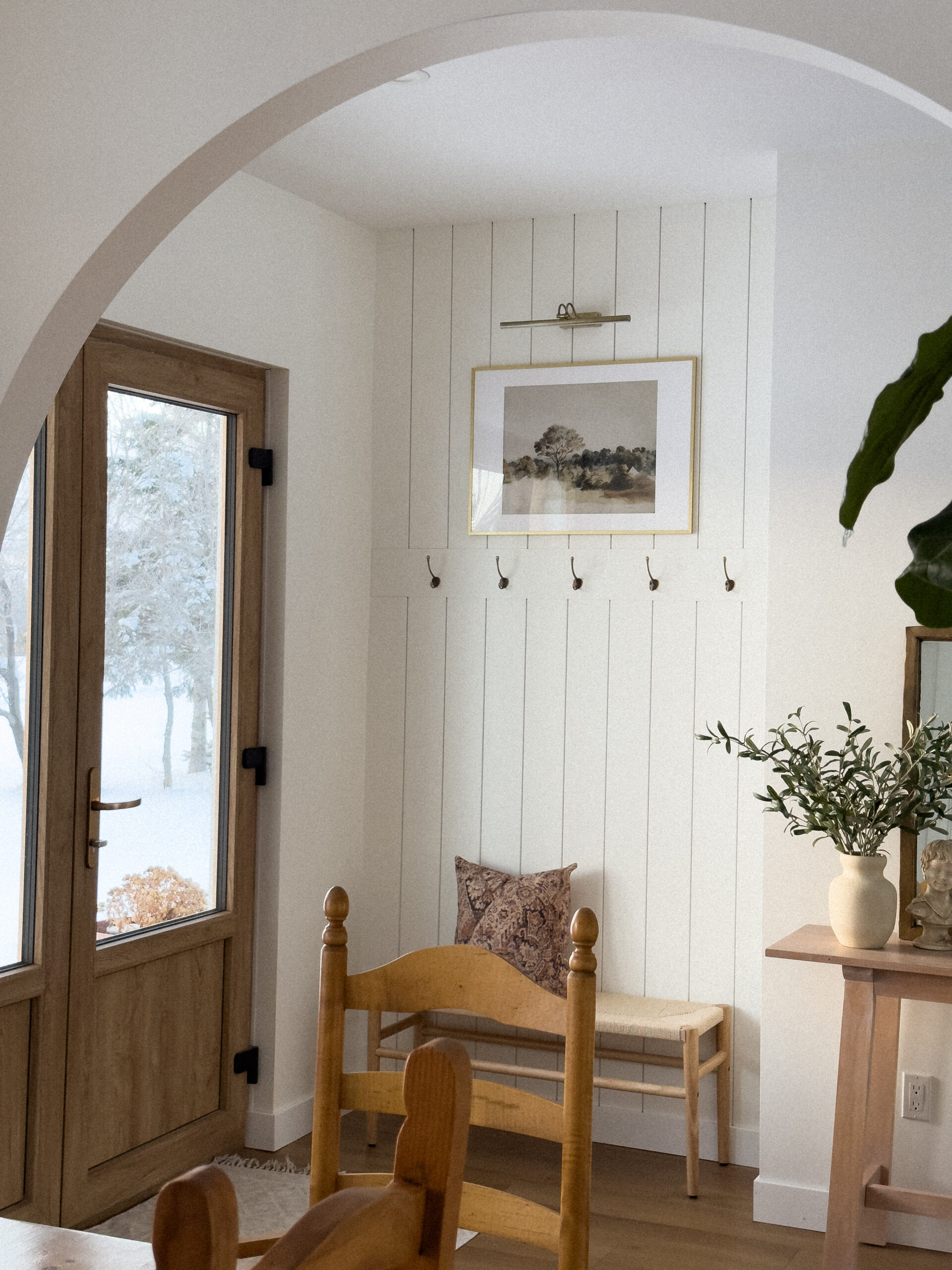 Transitional entrance nook with arched doorway