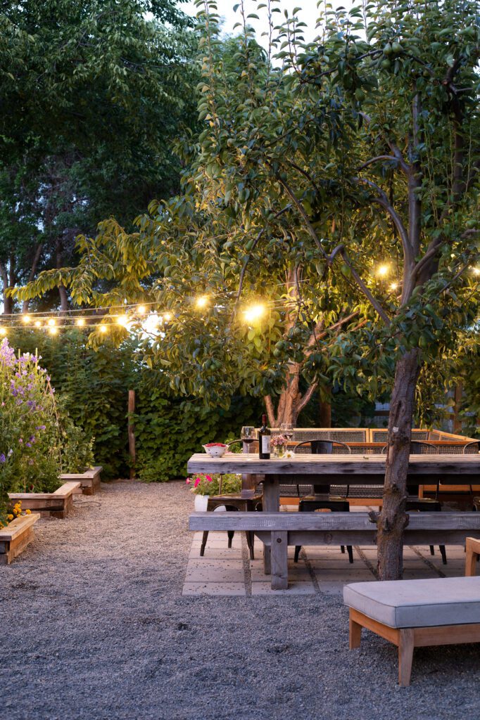 Outdoor space by garden with seating and cozy lighting