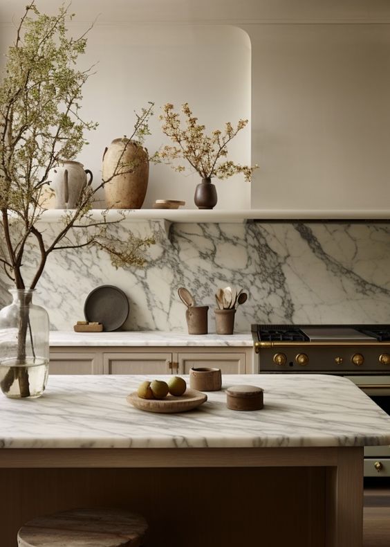 White kitchen with marble countertop and shelf