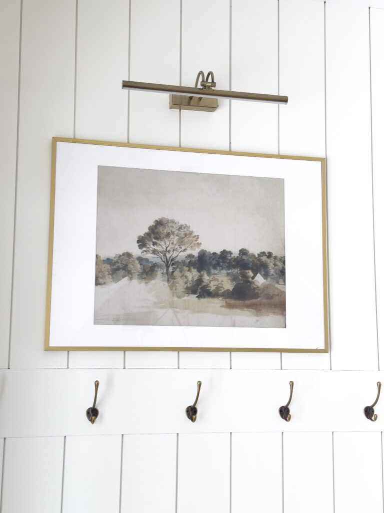 Vintage art print on shiplap entrance