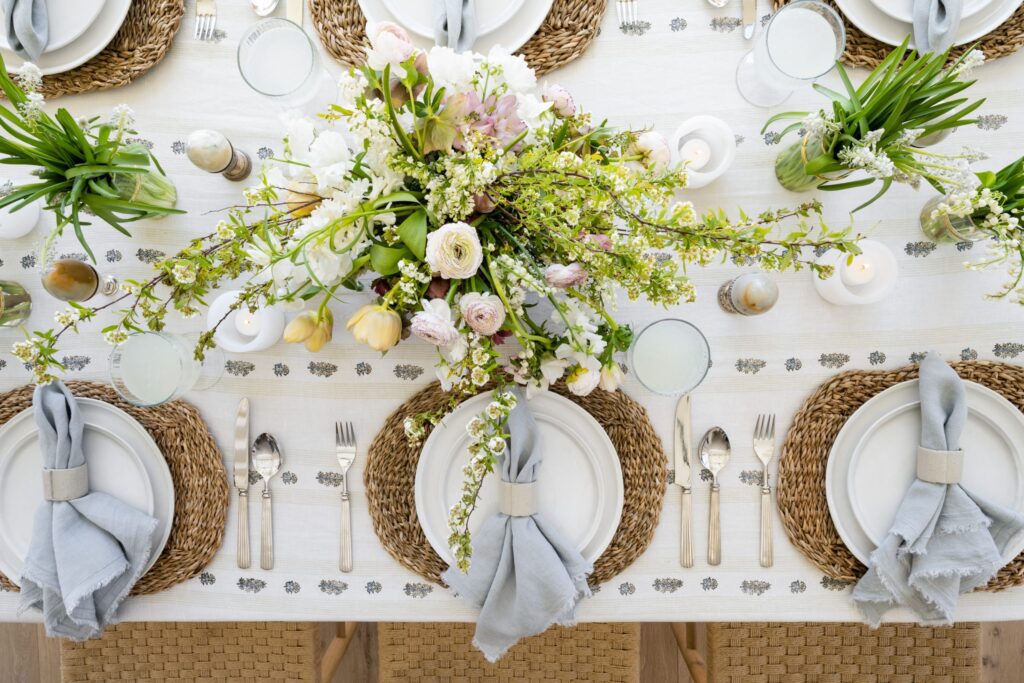 Easter table setting with bright florals and blue napkins