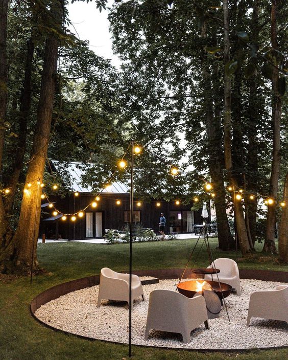 Modern fire pit deisgn with gravel and string lights