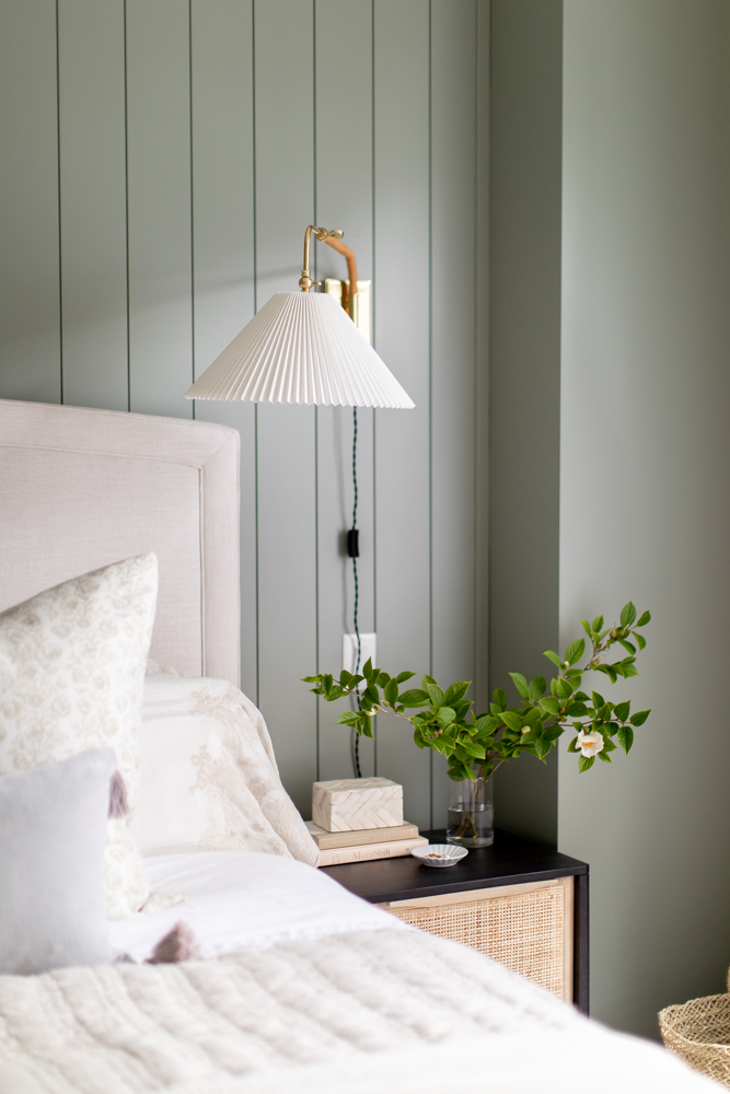 White wall sconce o green wall in master bedroom