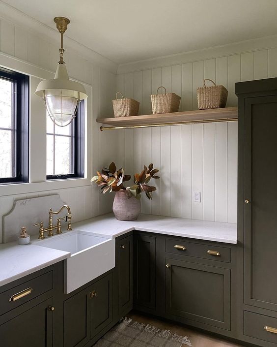 green laundry room with wall paneling