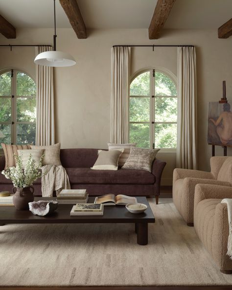 living room with arched windows and curtians