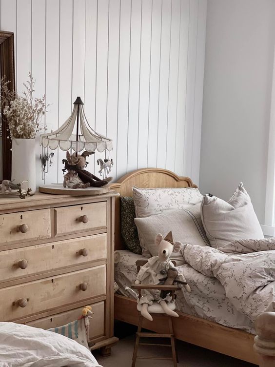 Scandinavian kids bedroom with wooden bed and soft textiles