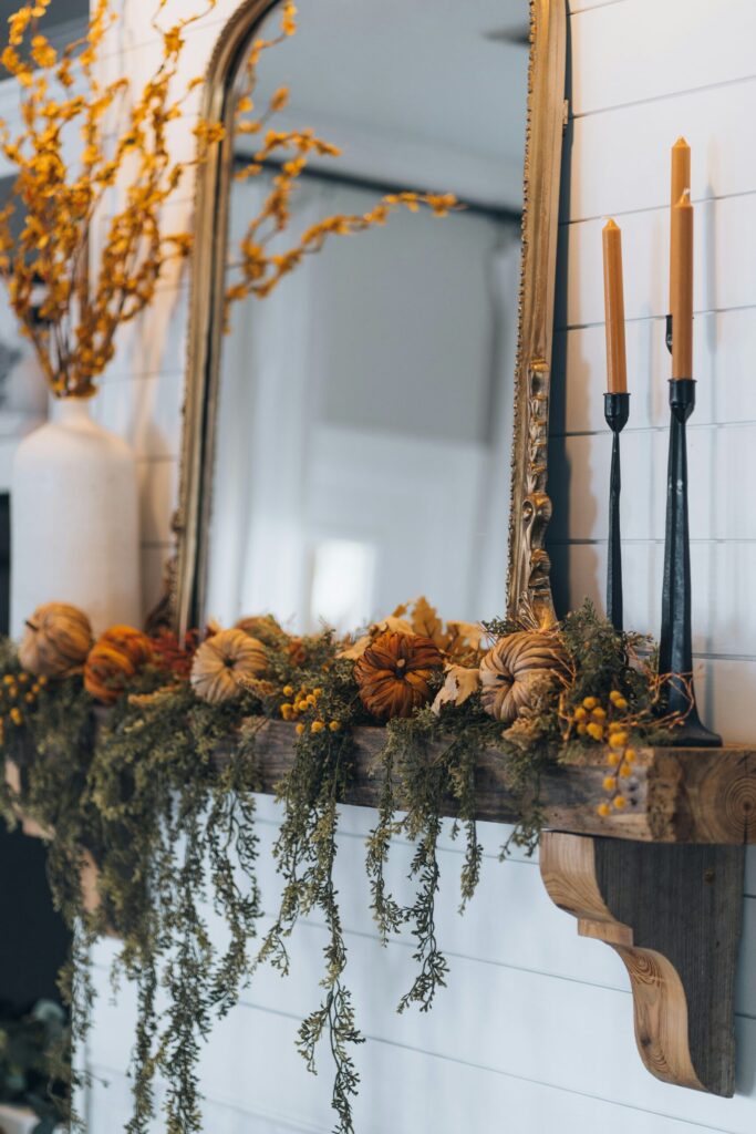 Fall mantle decor with mini pumpkins and greenery